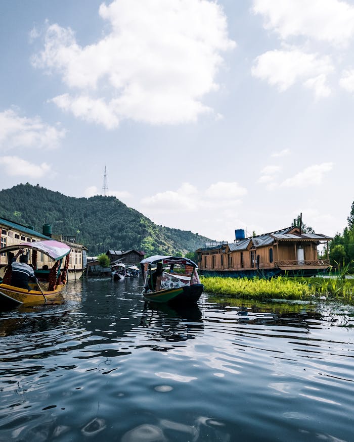 Explore tranquility on a serene mountain lake with boats and nature.