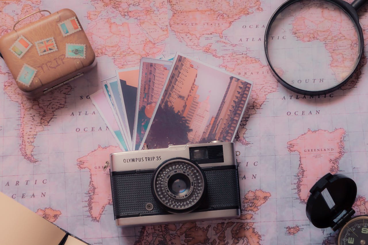 about-01 Explore vintage photography with a classic camera and travel-themed setup over a world map.
