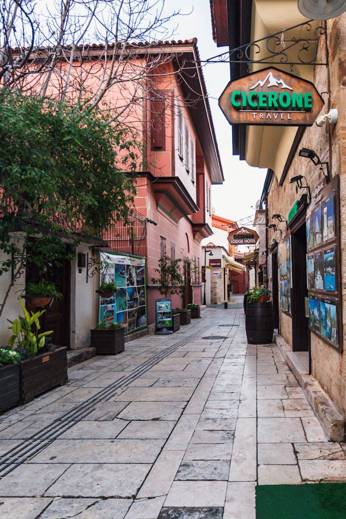 services-01 Picturesque alleyway in Antalya, Turkey showcasing travel agency signs and cozy architecture.