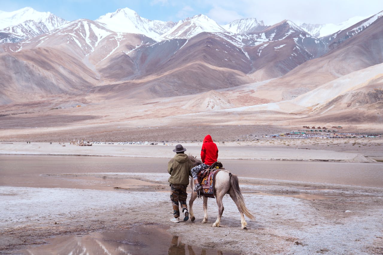 gallery-6 A serene horseback ride along the shores of Pangong Lake, surrounded by the majestic Himalayas.